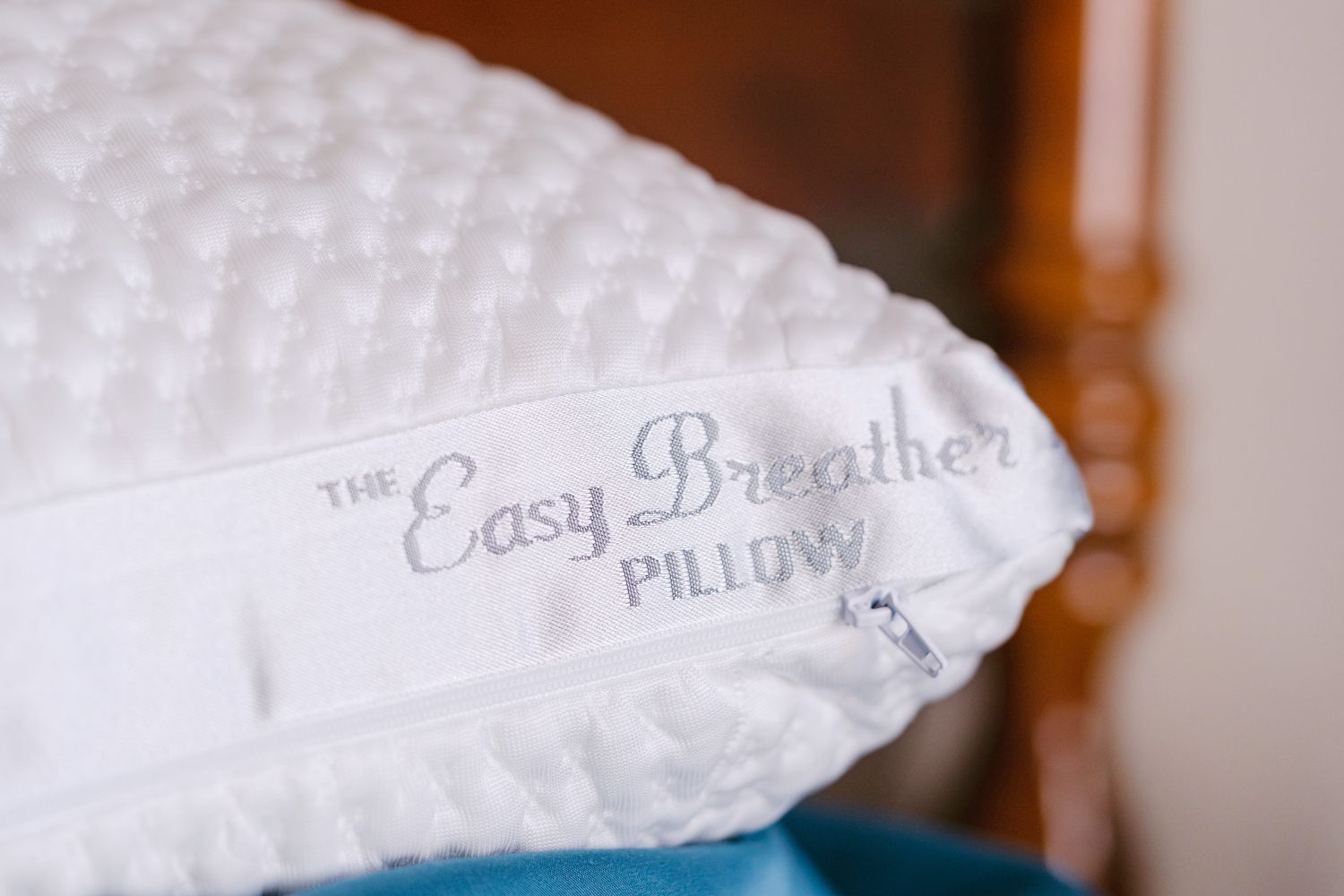 Closeup of Nest Bedding Easy Breather Natural Pillow logo and zipper 