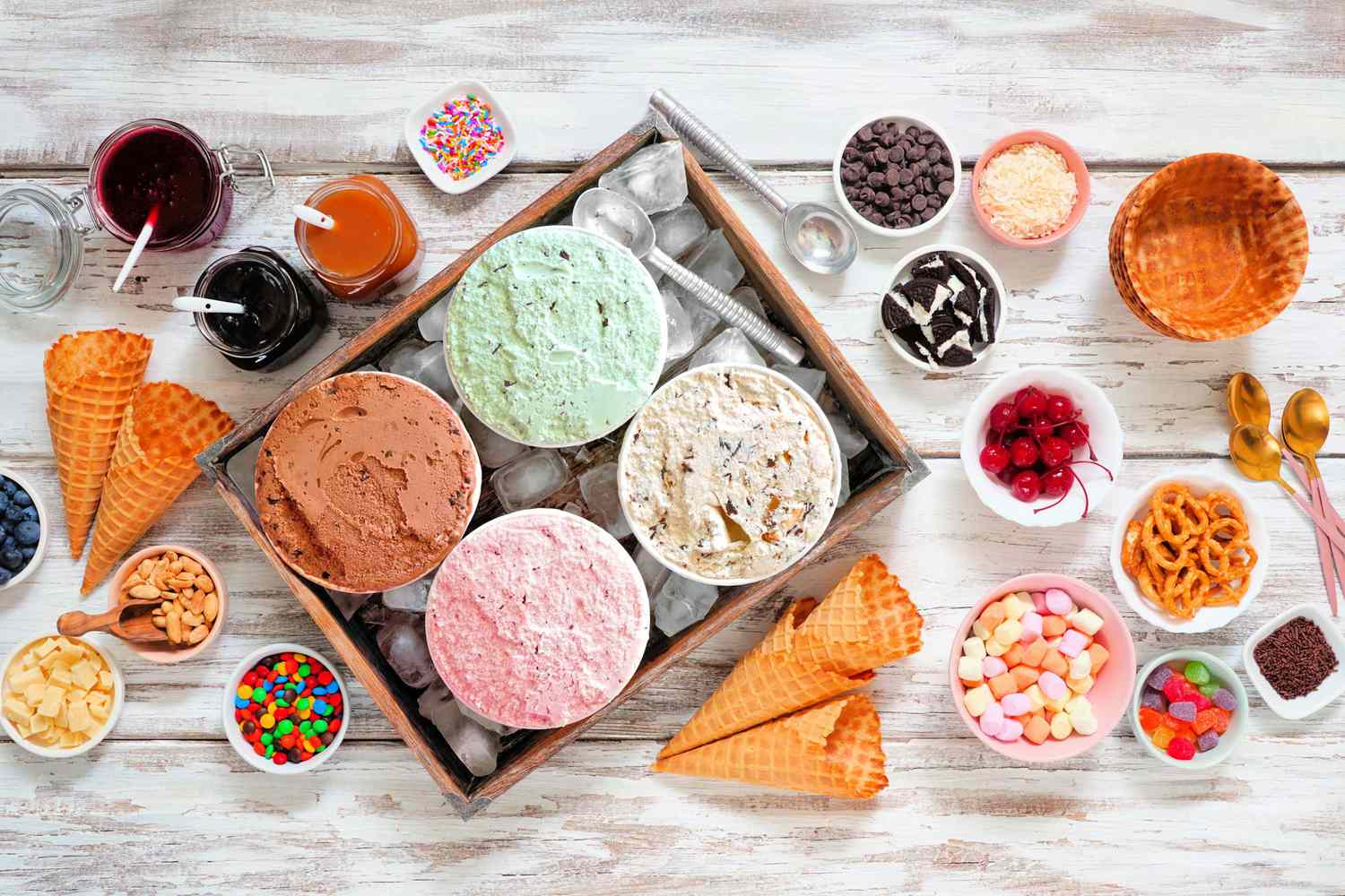 ice cream bar top view table scene on a rustic white wood background