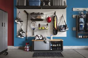 organized garage with blue paint and storage wall