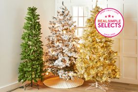 A selection of artificial Christmas trees that we recommend placed in the corner of a room by a window