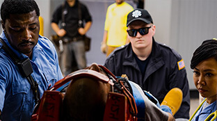 EMS responder treating a patient on a gurney