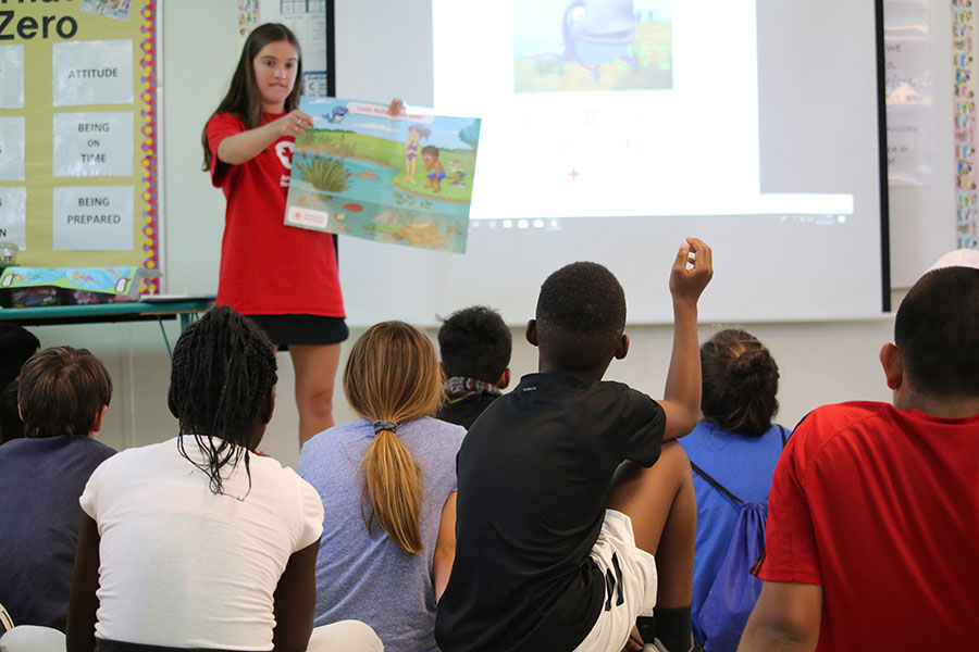 Instructor teaching water safety to children in classroom