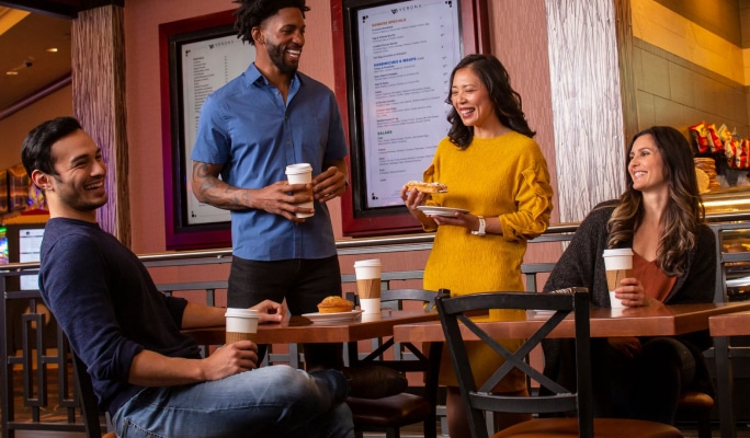 People chatting around a table in Verona Coffeehouse