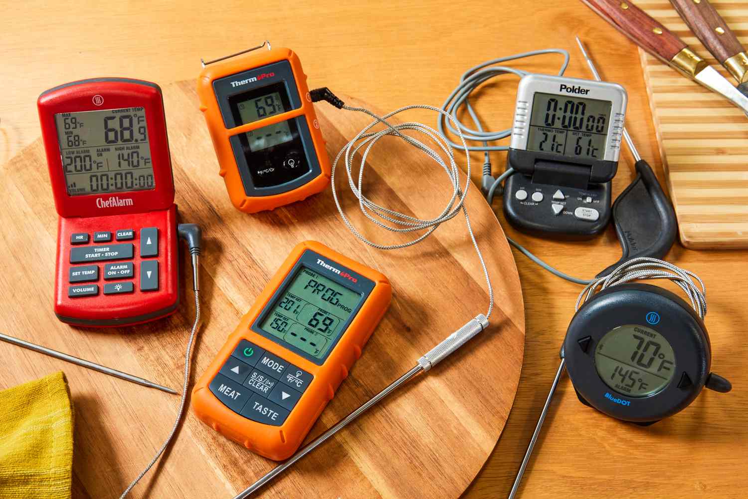 four probe thermometers on a wooden table