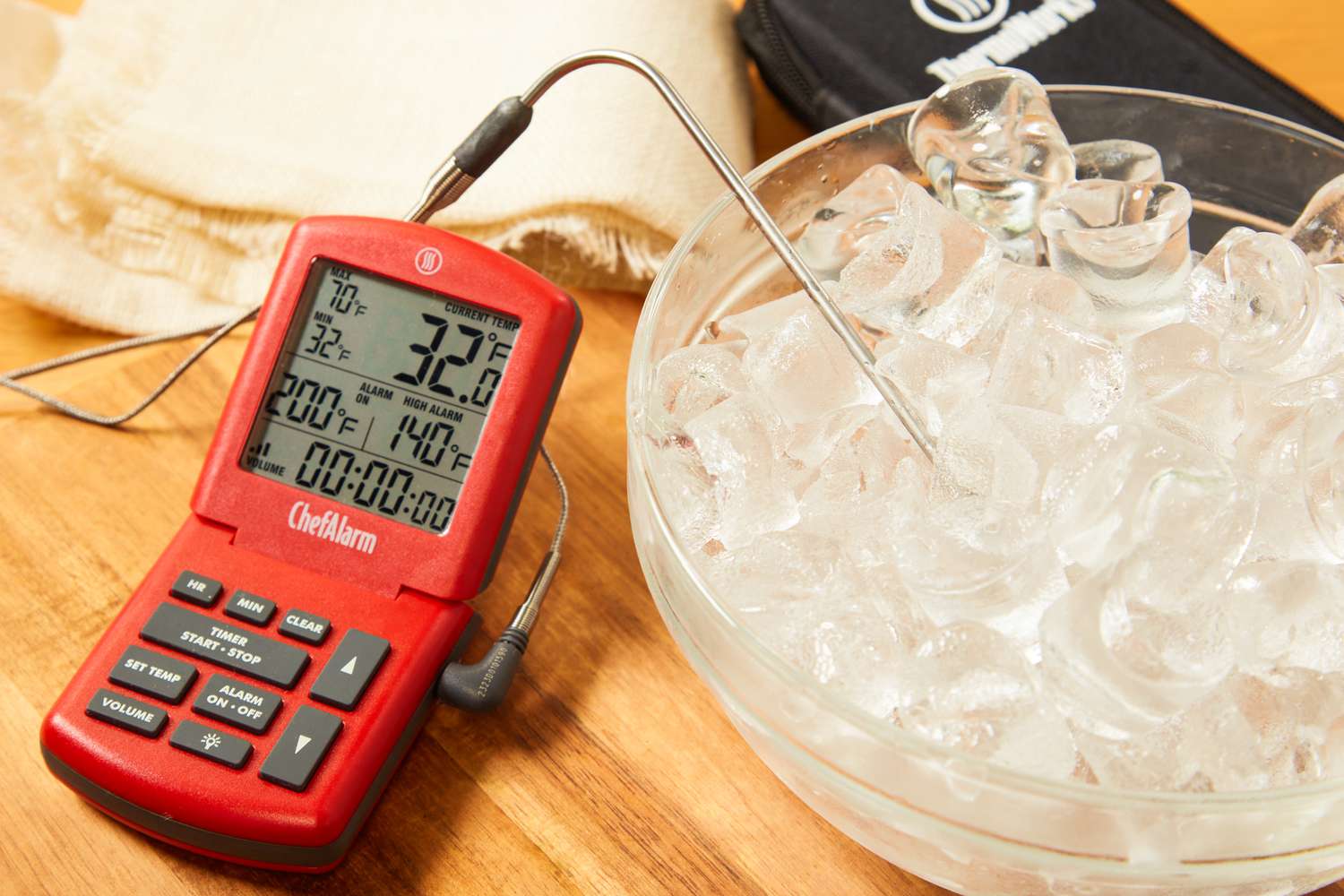 a probe thermometer being used to take the temperature of a bowl of ice