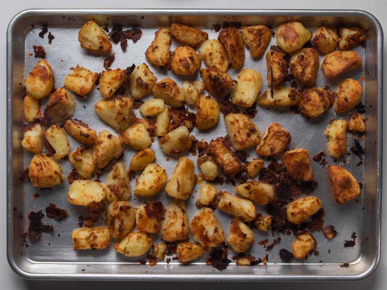 The best ever crispy roast potatoes on a metal baking sheet.