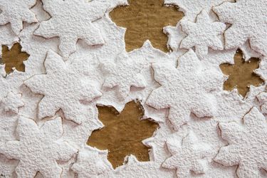 Overhead of sugar cookies covered in thick layer of powdered sugar