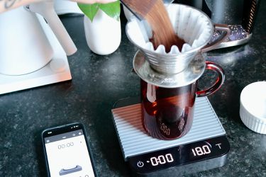 Pouring coffee into pourover maker set on the Acaia Pearl scale