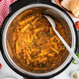 Ziti cooked in the instant pot with a spoon to scoop it out.