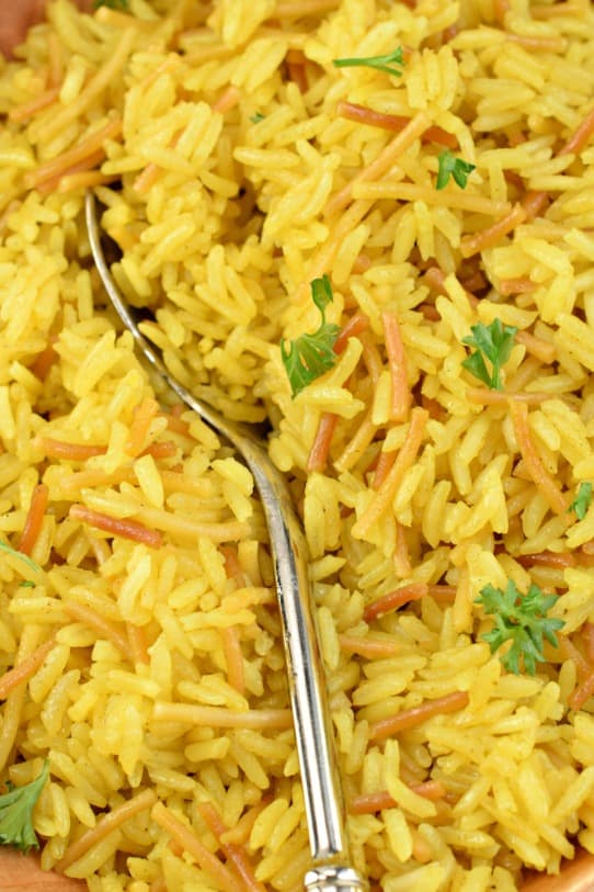 Fluffy rice a roni closeup with silver spoon and fresh parsley.