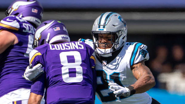 Oct 1, 2023; Charlotte, North Carolina, USA; Carolina Panthers safety Jeremy Chinn (21) sacks Minnesota Vikings quarterback Kirk Cousins (8) in the second quarter at Bank of America Stadium.