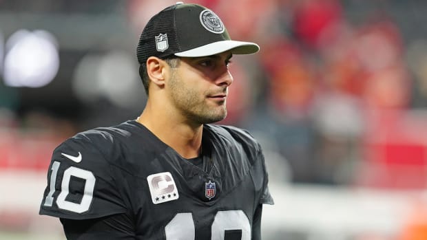 Jimmy Garoppolo watches from the sidelines.