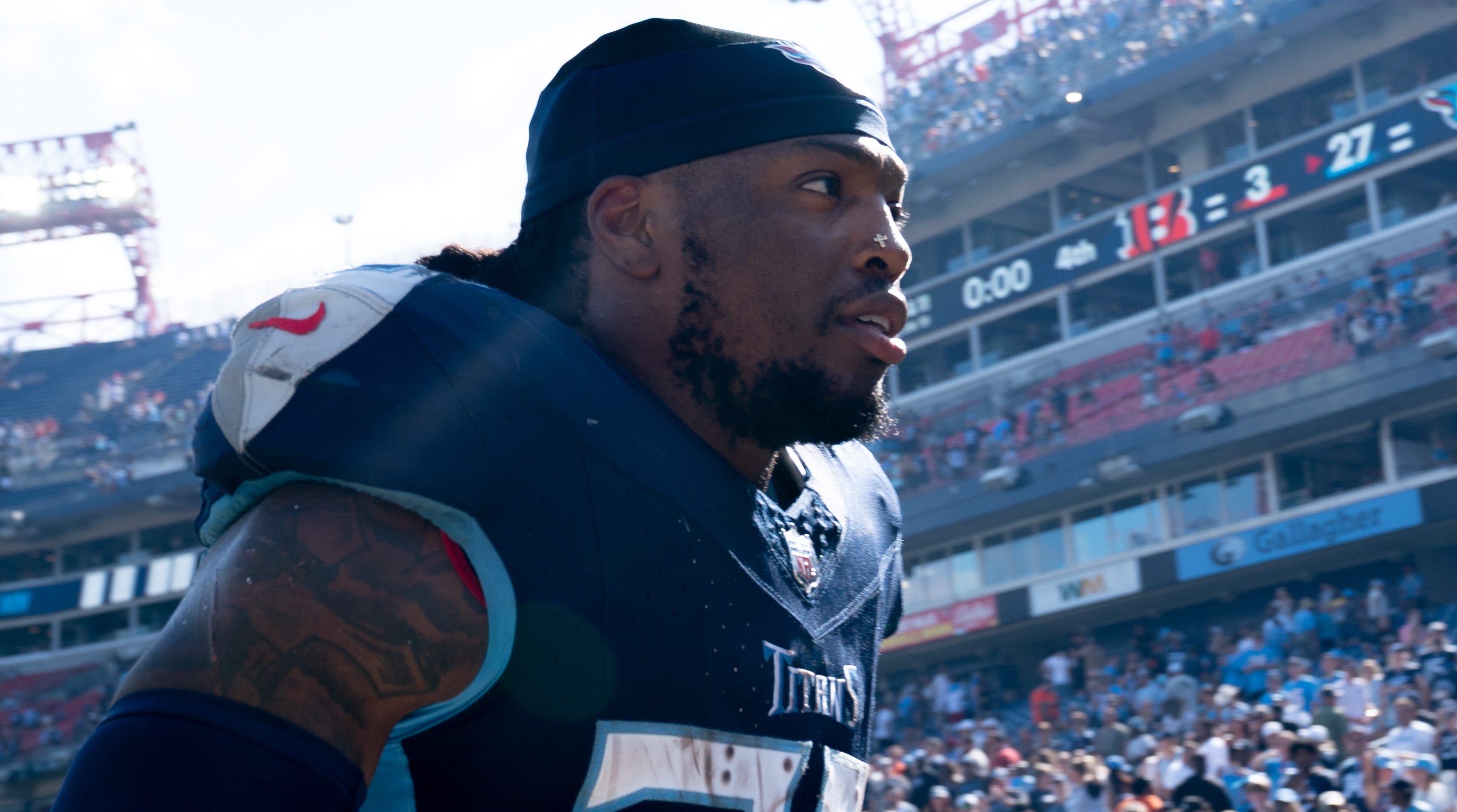 Titans running back Derrick Henry jogs off the field