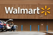 A shopper loads her car after shopping at a Walmart in Pittsburgh on Thursday, Feb. 22, 2018. Walmart announced Tuesday, April 30, 2024, it is closing its health centers and virtual care service,  as the retail giant has struggled to find success with the offerings.