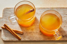 Southern Living Hot Apple Cider in mugs with cinnamon sticks to serve