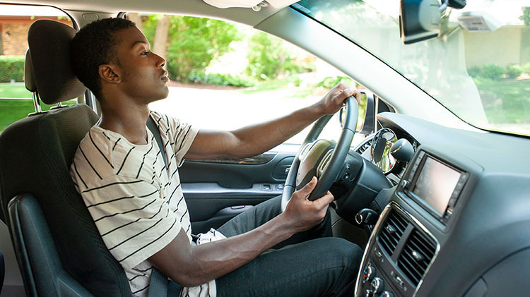 A young man keeps his eyes on the road