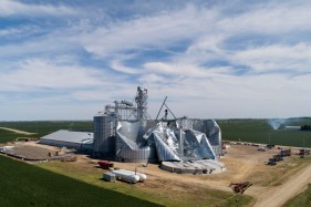 Crushed grain bins in a field