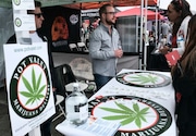 FILE - This March 31, 2018 photo shows a booth advertising a delivery service for cannabis at the Four Twenty Games in Santa Monica, Calif. Police chiefs and cities are working together to block a proposed state rule that they say would allow unchecked home marijuana deliveries anywhere in California, even into places that have banned cannabis sales. California Police Chiefs Association President David Swing says in a statement that the change would "open the floodgates" for potential criminal activity. (AP Photo/Richard Vogel, File) ORG XMIT: POR2018091813404883 Third-Party-Submitted