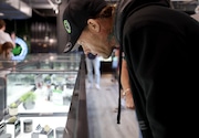 Champ Winchell of Syracuse looks at product on a window case. Flynnstoned a marijuana dispensary has a soft opening, Owned by Mike Flynn.  June 13, 2023. Dennis Nett | dnett@syracuse.com