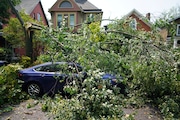 The aftermath of a sudden storm on Prospect Avenue in Buffalo, N.Y., Monday, Aug. 5, 2024. (Derek Gee/The Buffalo News via AP)