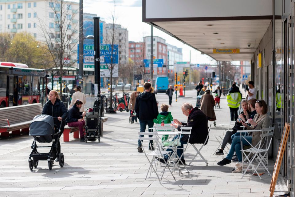  People are pictured here earlier this month eating and hanging in Sweden