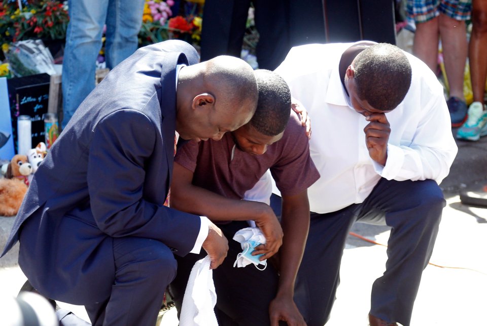  Quincy Mason, center, the son of George Floyd, and family attorney Ben Crump, left, kneel, Wednesday, June 3, 2020 as they visited the site of a memorial in Minneapolis where Floyd was arrested