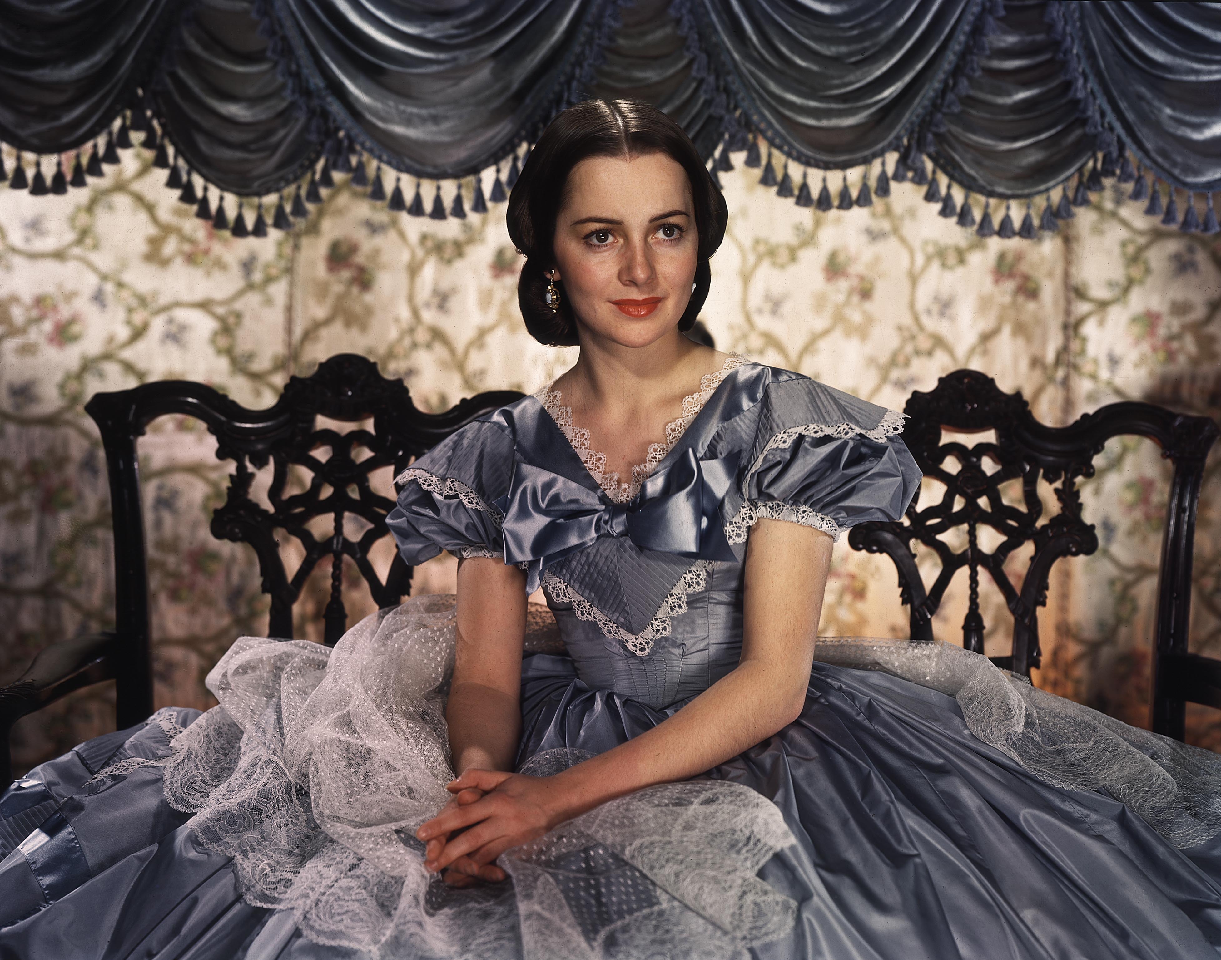 De Havilland starred in Gone With the Wind as Melanie Hamilton Wilkes, a foil to the film's protagonist Scarlett O'Hara