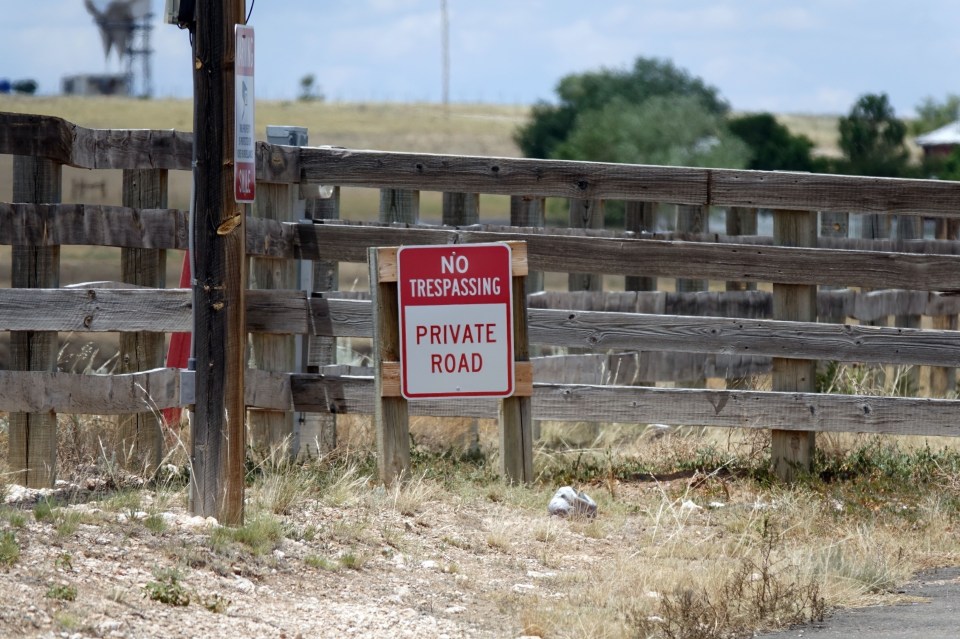  A no trespassing sign is seen at the wooden gate to the private road after a recent break-in