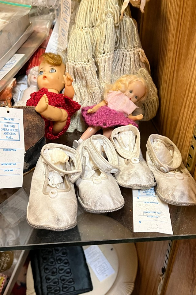 Vintage baby shoes have dirt on them