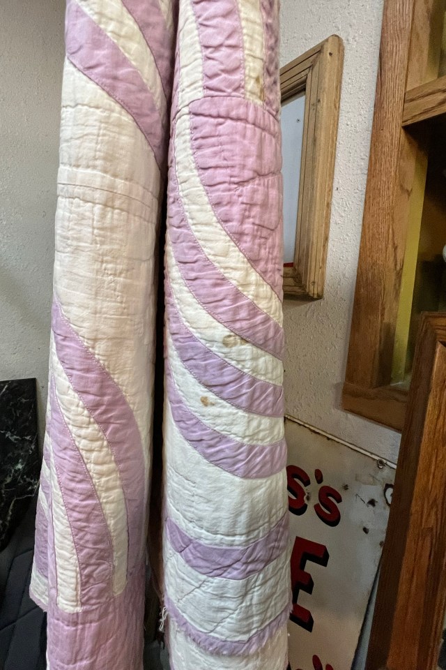 A vintage blanket has dark red stains