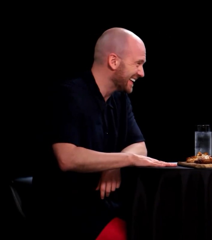 Hot Ones host Sean Evans blushed and smiled nervously as he told Heidi Klum she was making him hot