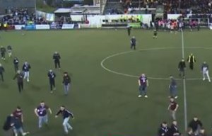 Watch shock moment fans run on pitch and huge brawl breaks out in 'ugly' scenes