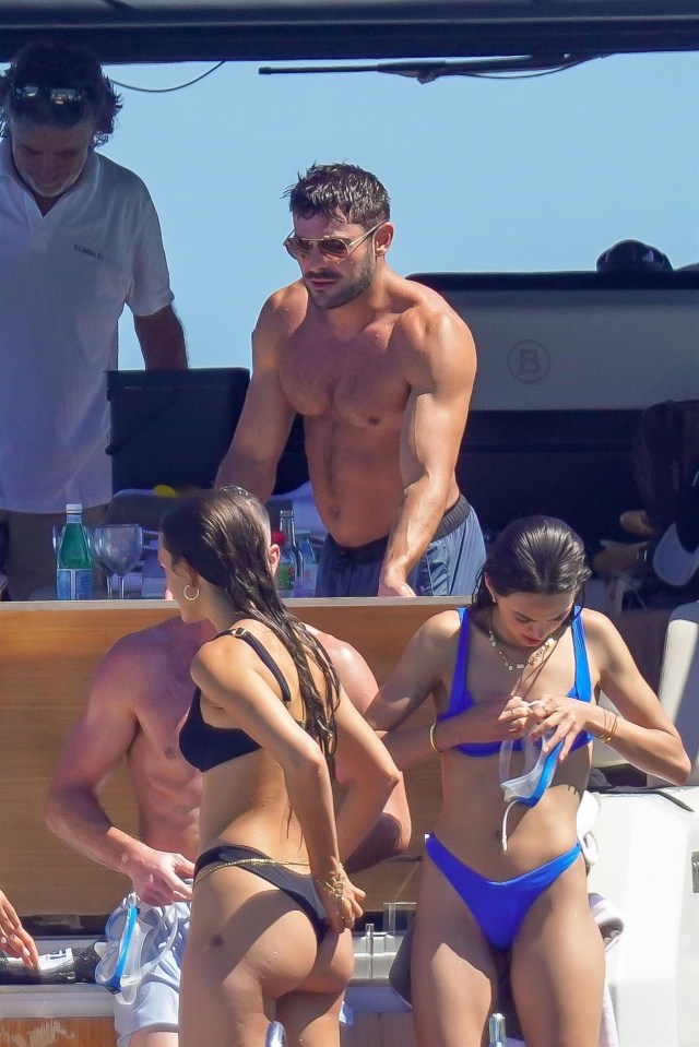 Zac Efron is photographed after just taking a swim in the St. Tropez water as one partyer is seen adjusting her goggles