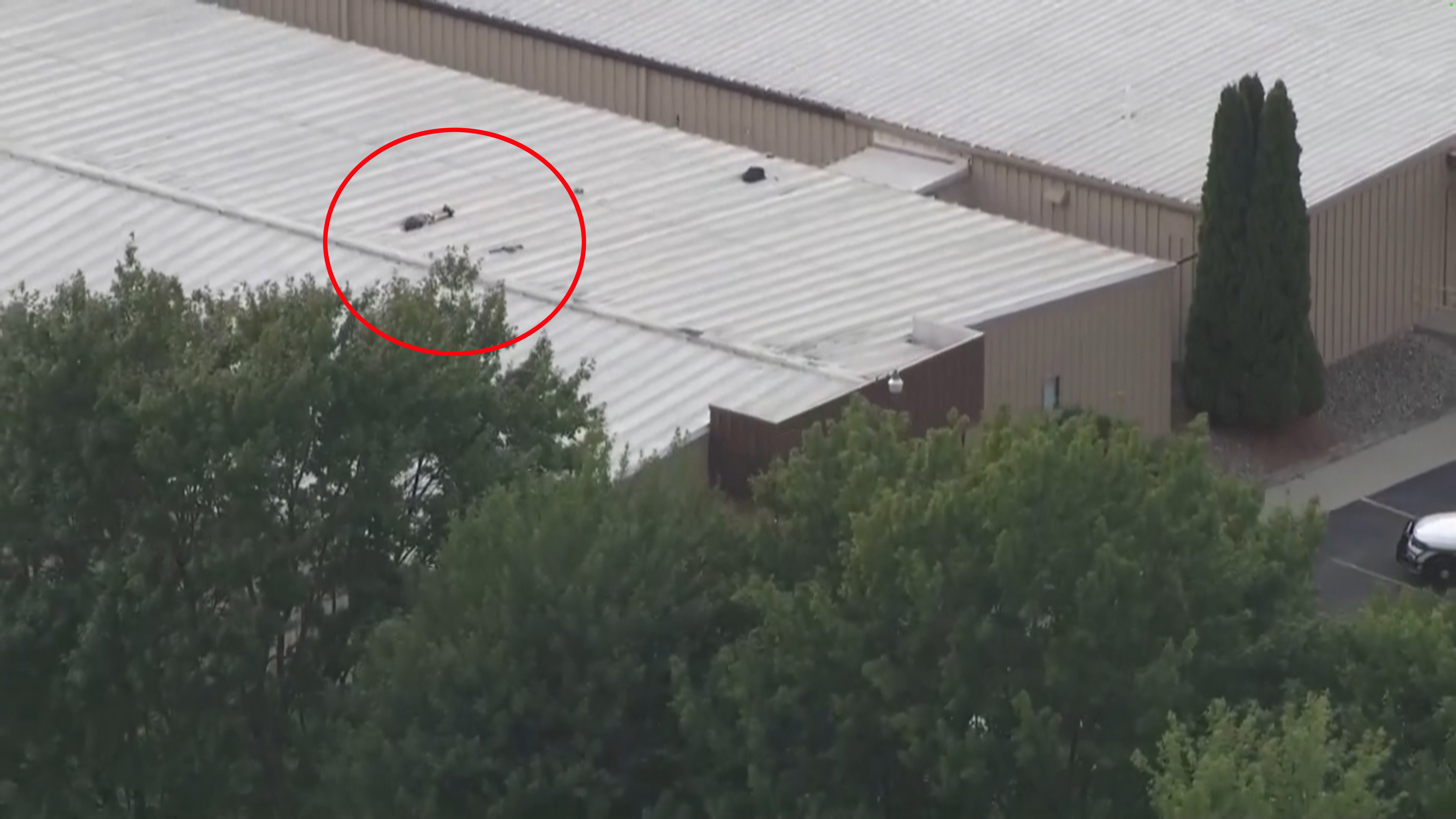 A birds-eye view of the shooter on the roof - who was taken out by snipers at the rally