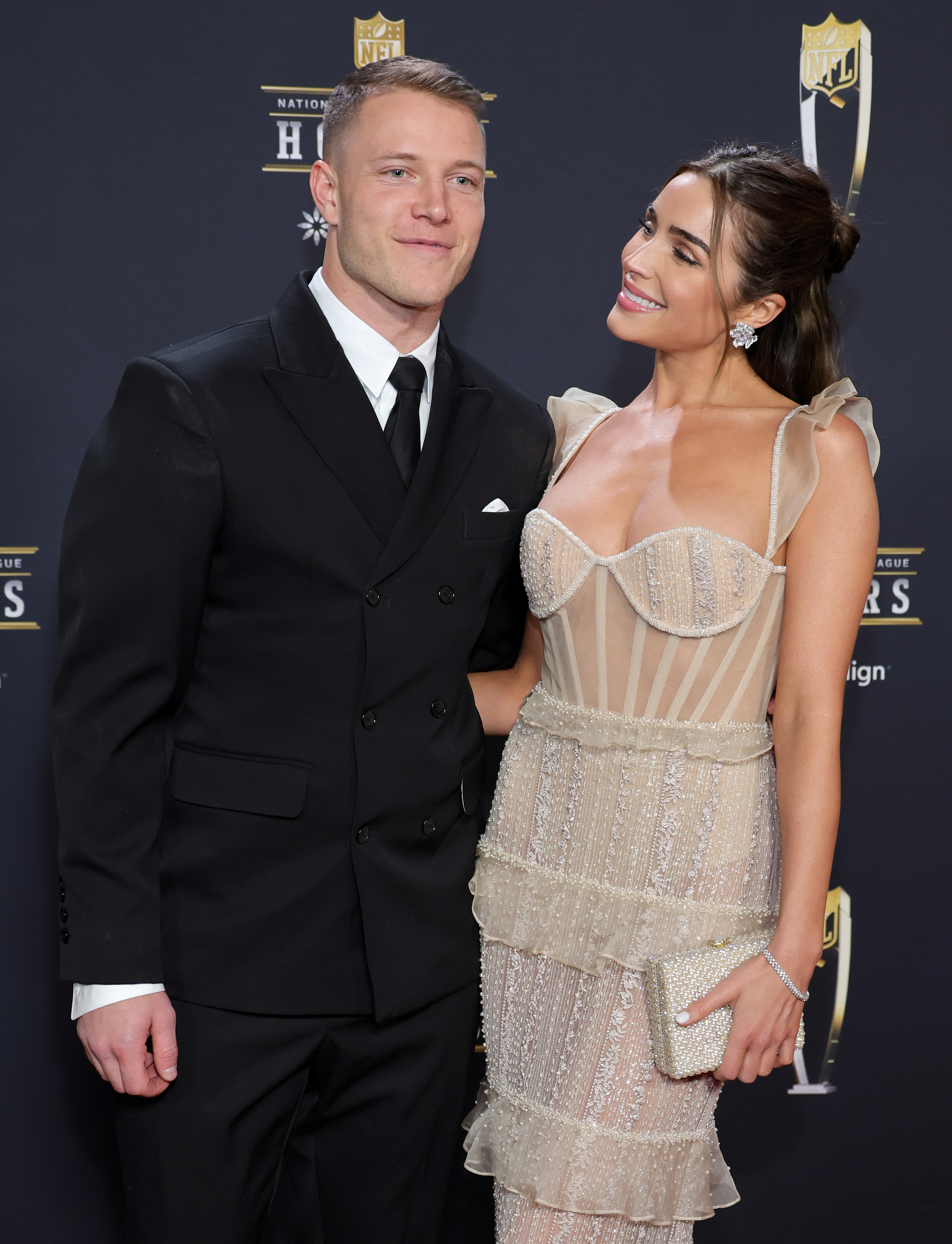 Christian McCaffrey and Olivia Culpo have defended her wedding dress