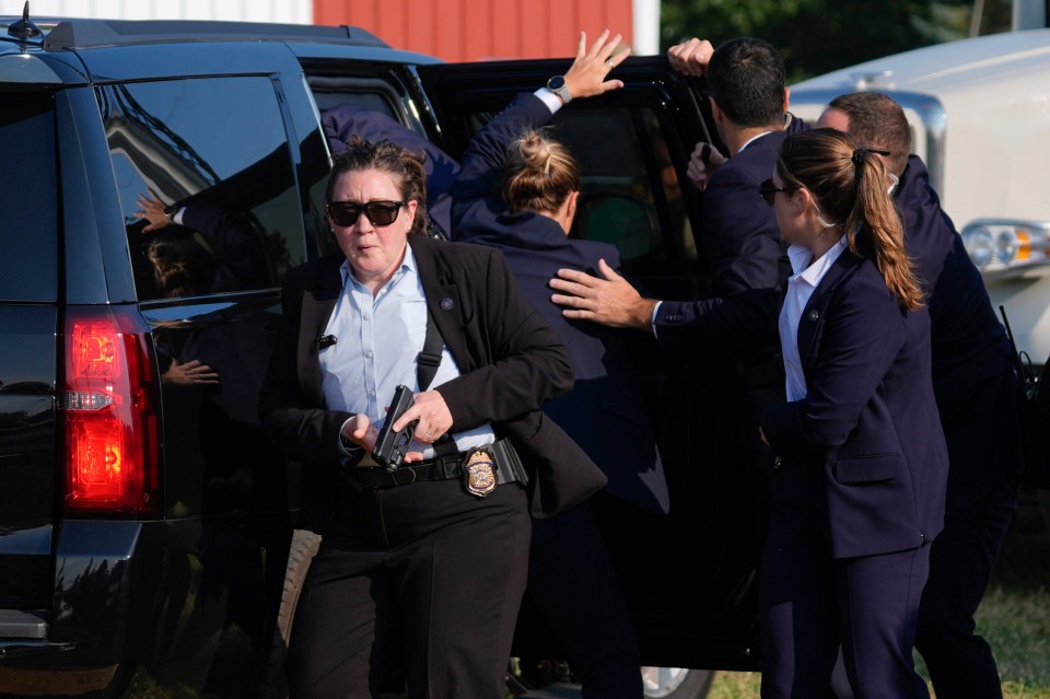 Republican presidential candidate former President Donald Trump is surrounded by U.S. Secret Service agents as he is taken to a vehicle at a campaign rally