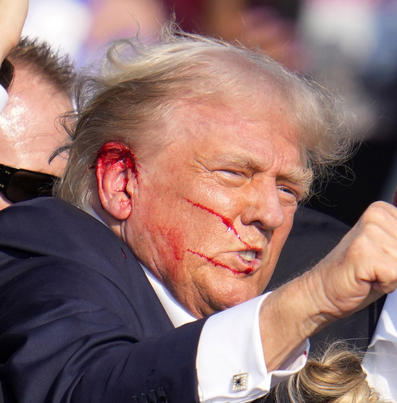 Blood smeared across the side of Trump's face after the shooting