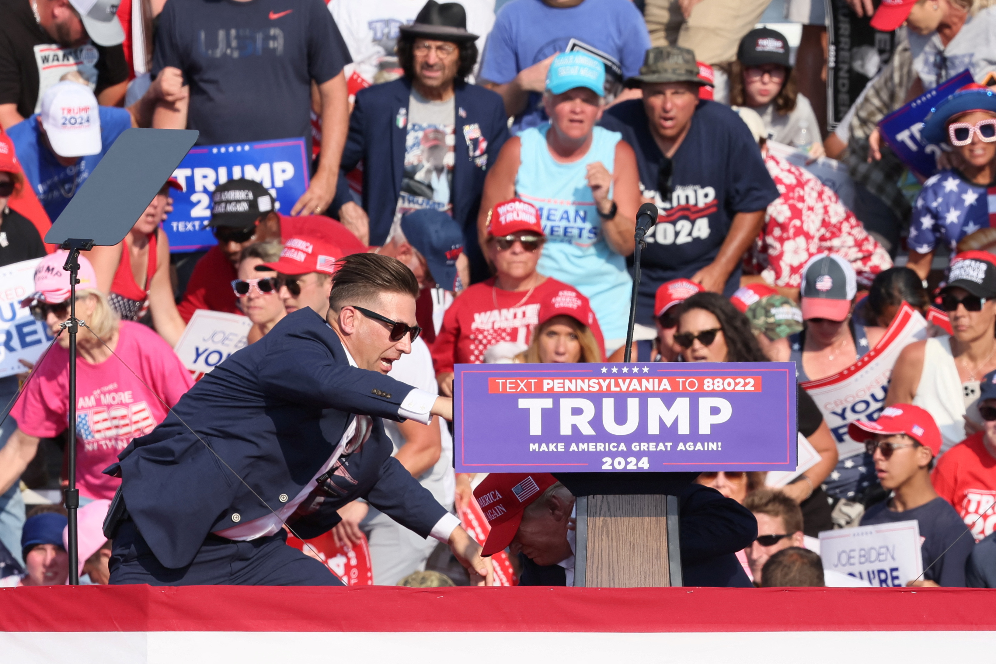 Republican presidential candidate Trump and security personnel hit the ground as multiple shots ring out