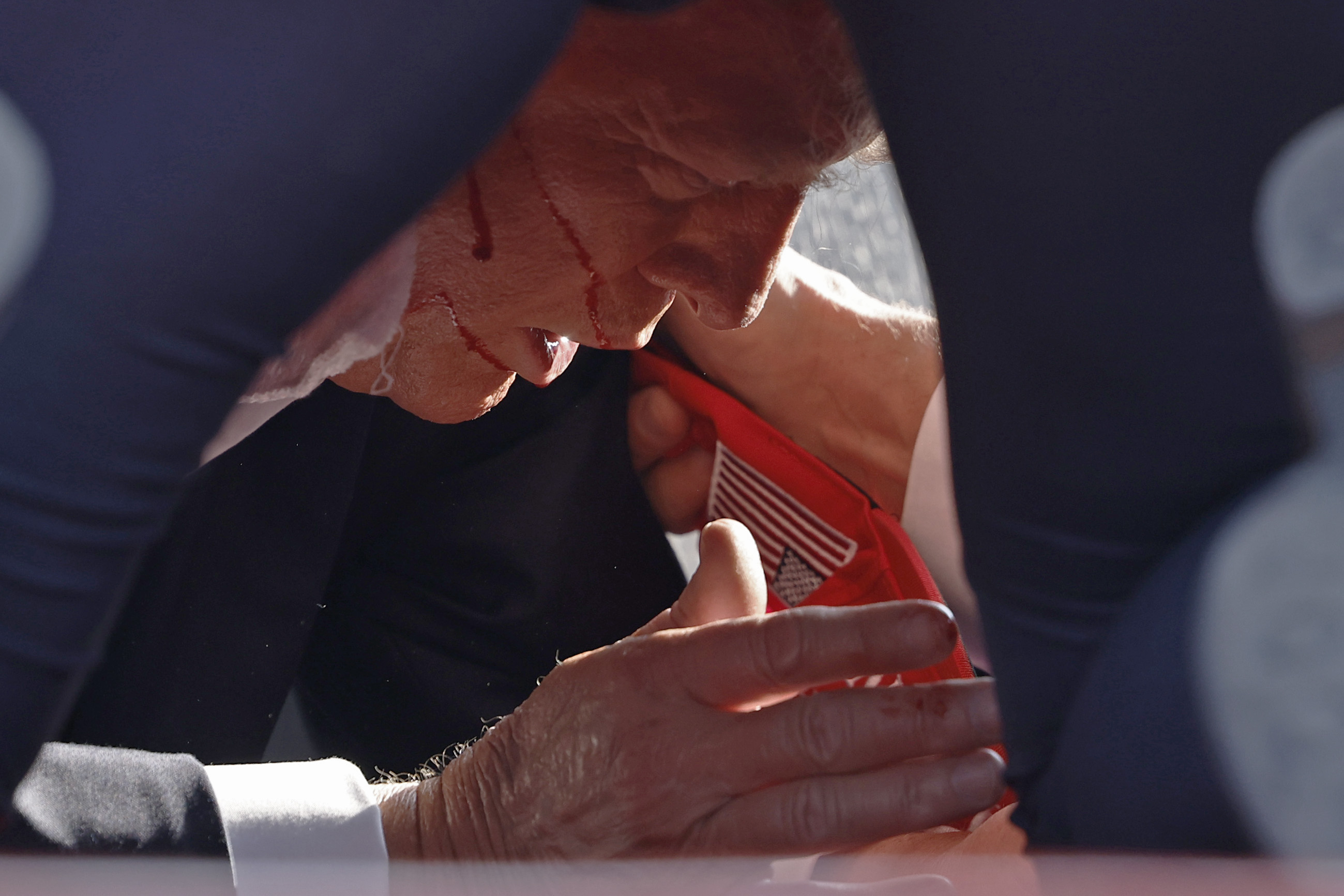 Trump hit the deck immediately after a bullet grazed his right ear