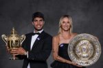 a man in a tuxedo and a woman in a black dress hold trophies