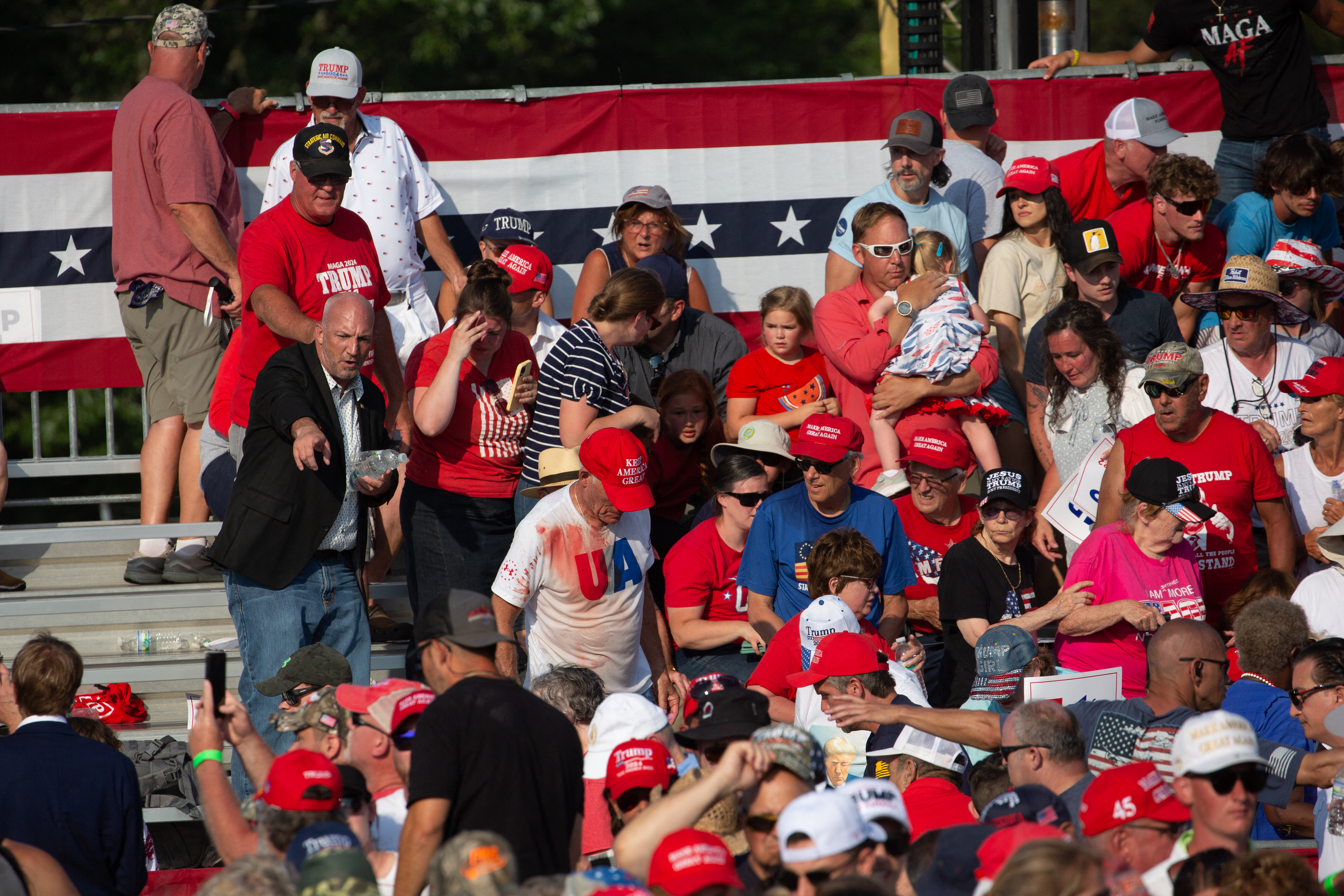 A man with a blood-soaked USA shirt spoke to reporters after the shooting