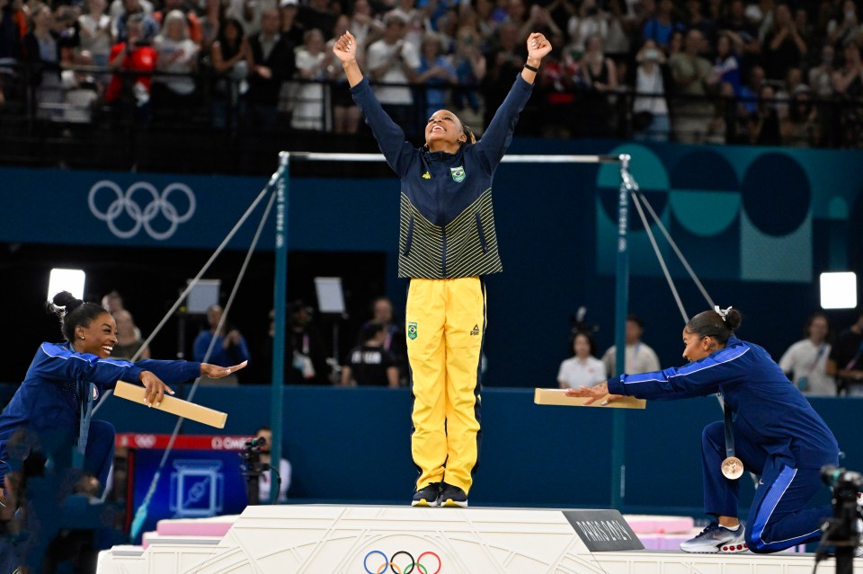 Biles and Chiles congratulate Brazil's Rebeca Andrade for winning gold in the individual floor event in a viral moment