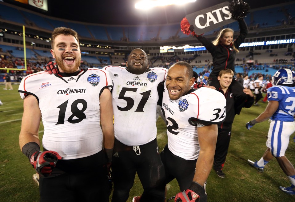 Kelce celebrating with his teammates after Cincinnati's win against Duke in the Belk Bowl in 2013