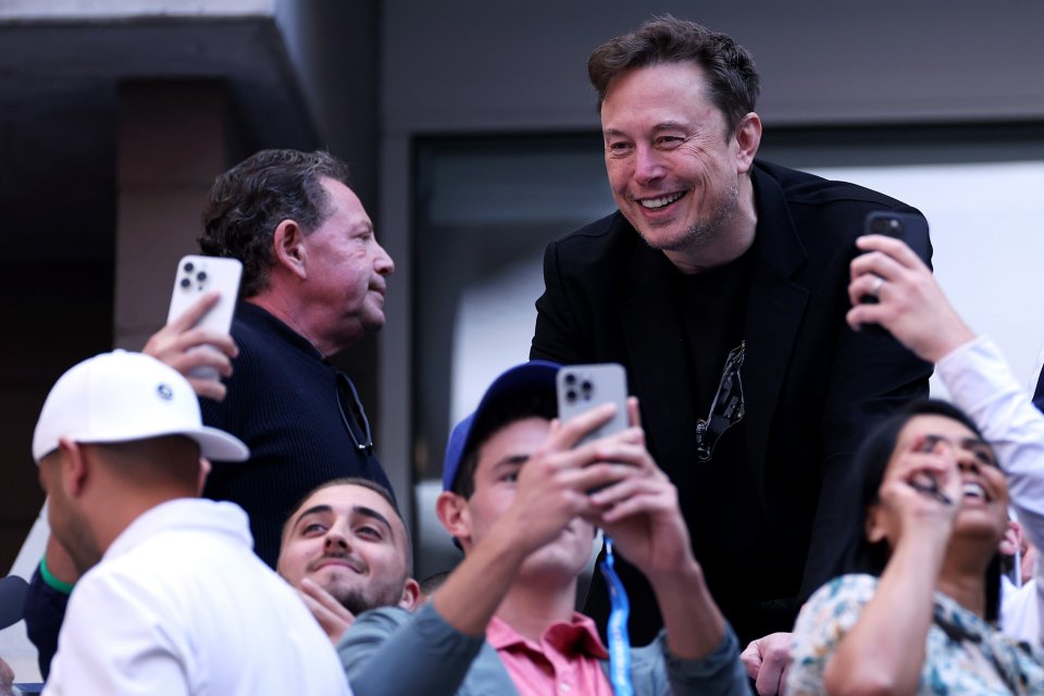 Musk appeared to pose for photos with fans as he enjoyed the match between Taylor Fritz and Jannik Sinner