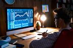 Man looking at computer screen with stock-market chart