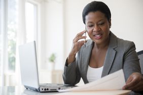 Black businesswoman talking on cell phone