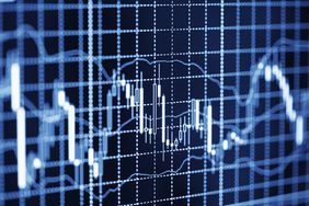 Candlestick chart shows Forex price movements on a black screen with blue and white grid lines