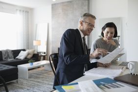 Financial advisor explaining a Keogh retirement plan with client in the client's home.