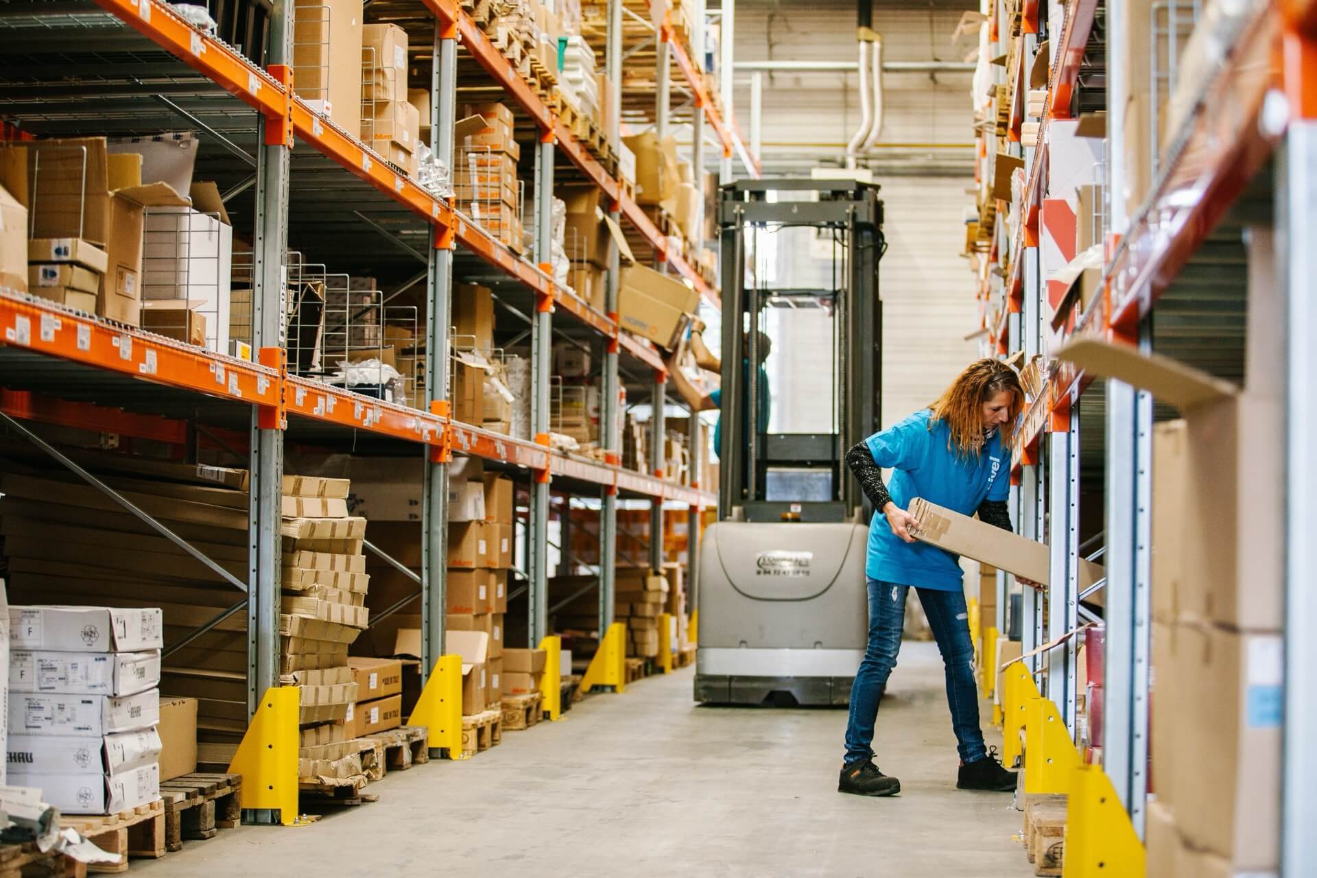 woman-at-work-putting-boxes-on-the-shelves-beside-2022-11-10-07-54-19-utc