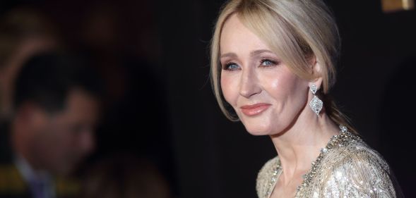 Harry Potter author JK Rowling wears a gold, glittery outfit as she poses for the camera